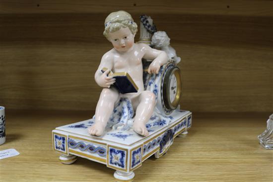 A late 19th century Meissen eight day mantel clock, surmounted by a cherub and objects emblematic of the arts